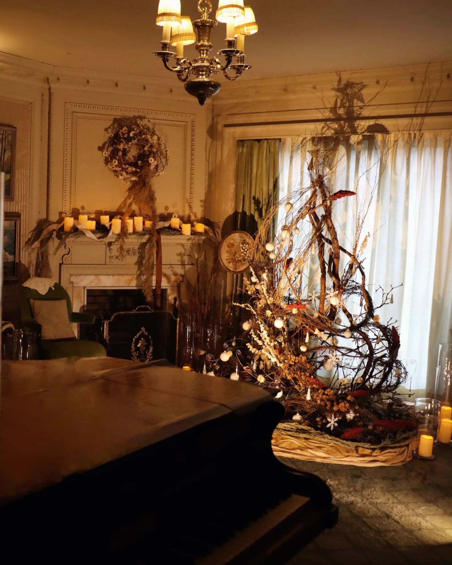 A living room with a piano and a christmas tree