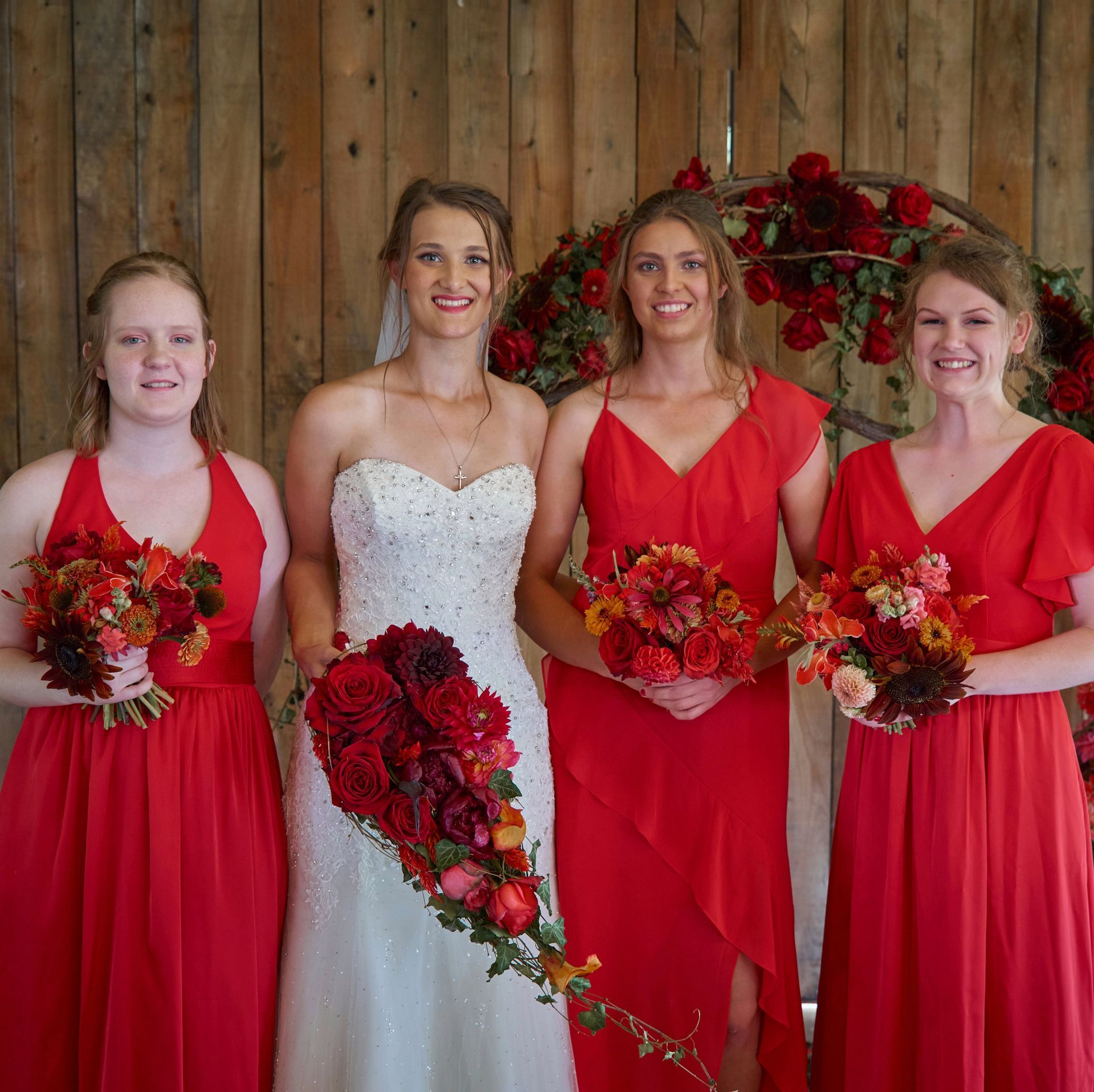A bride and her bridesmaids are posing for a picture