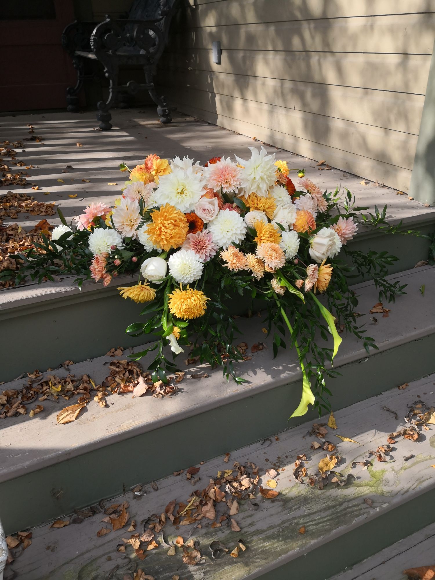 A bunch of flowers are sitting on top of a set of stairs.