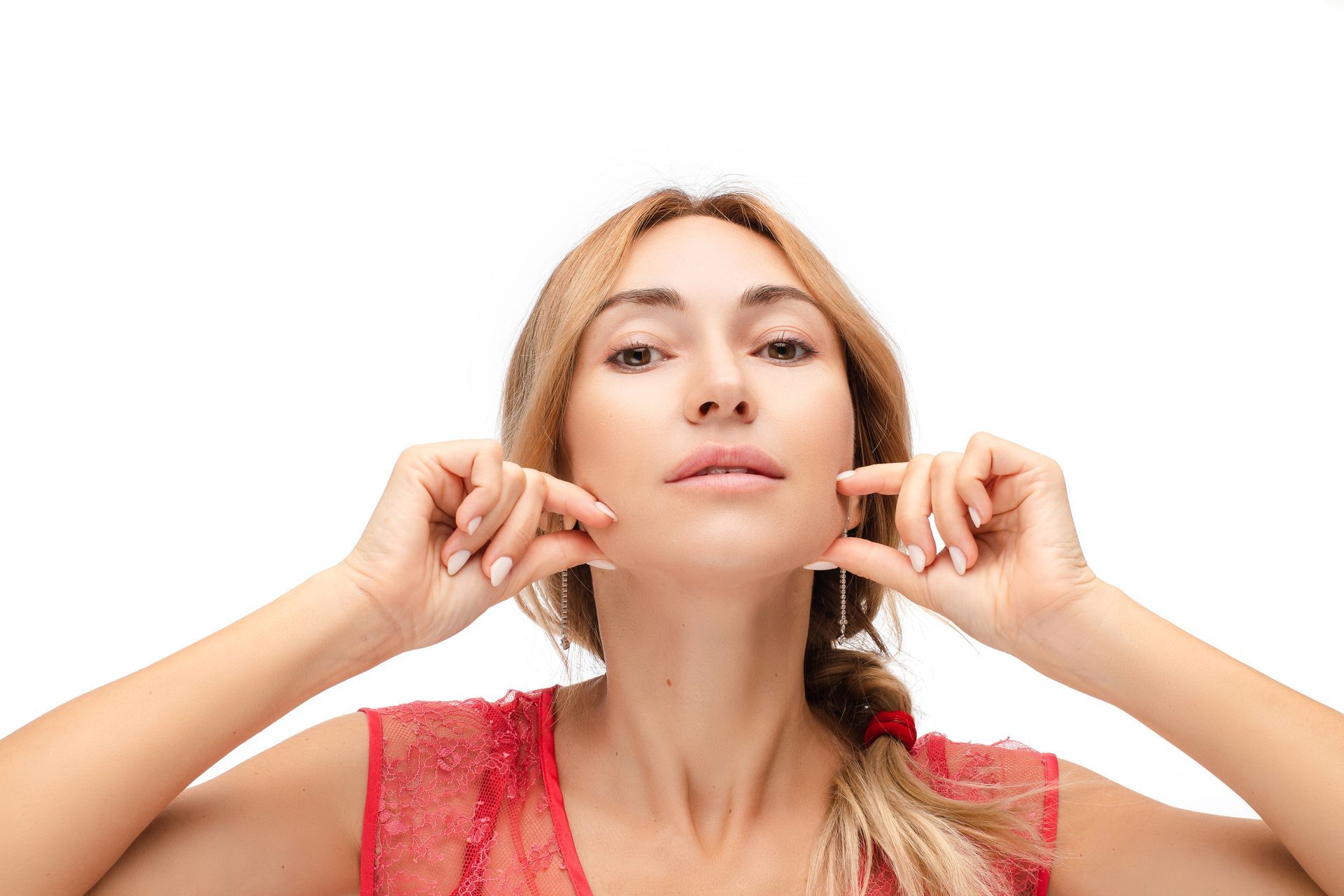 Girl holds her jawline flaunting the effects of Kybella treatment.