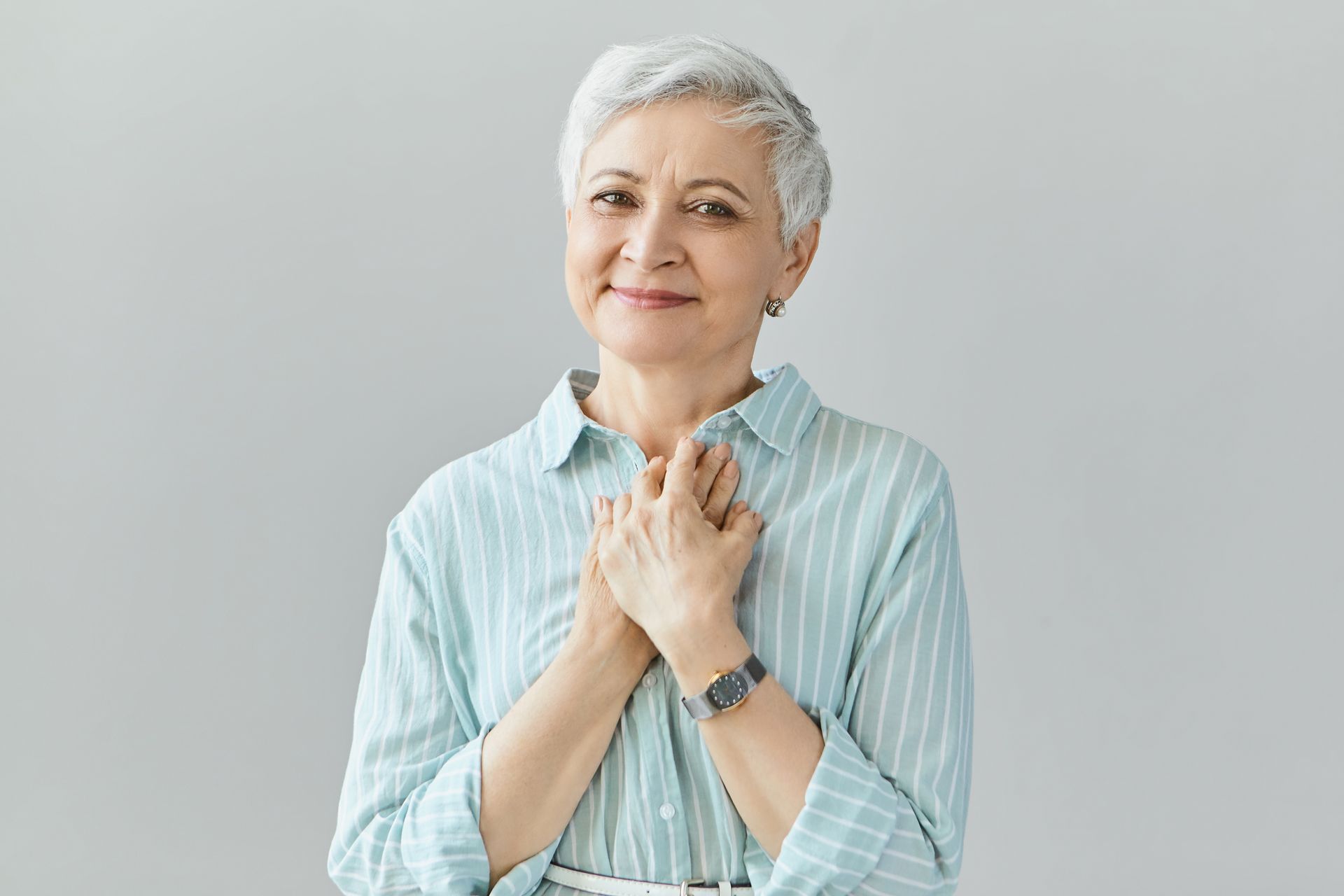 A woman is touching her chest