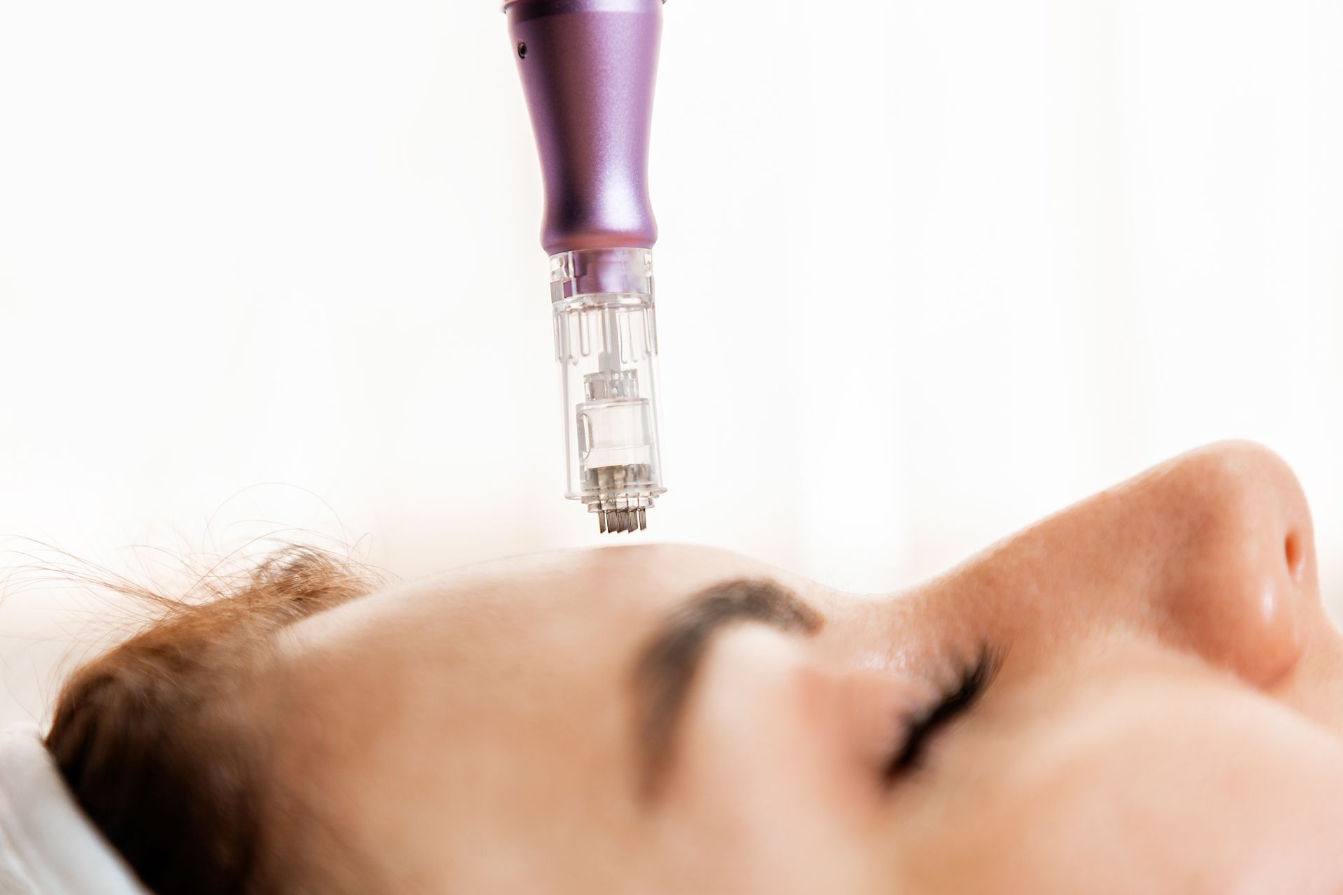 A woman is getting a facial treatment at a beauty salon.