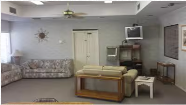 A living room with a couch and a television