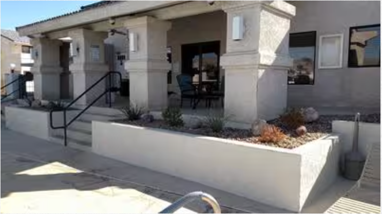 A white building with a porch and stairs