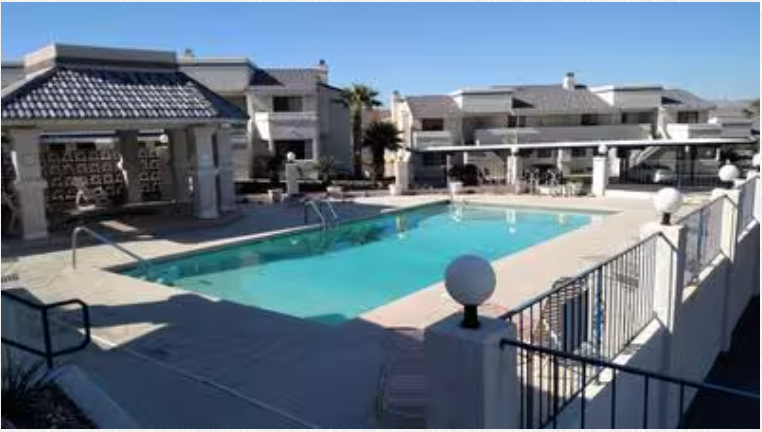 A large swimming pool in front of a building