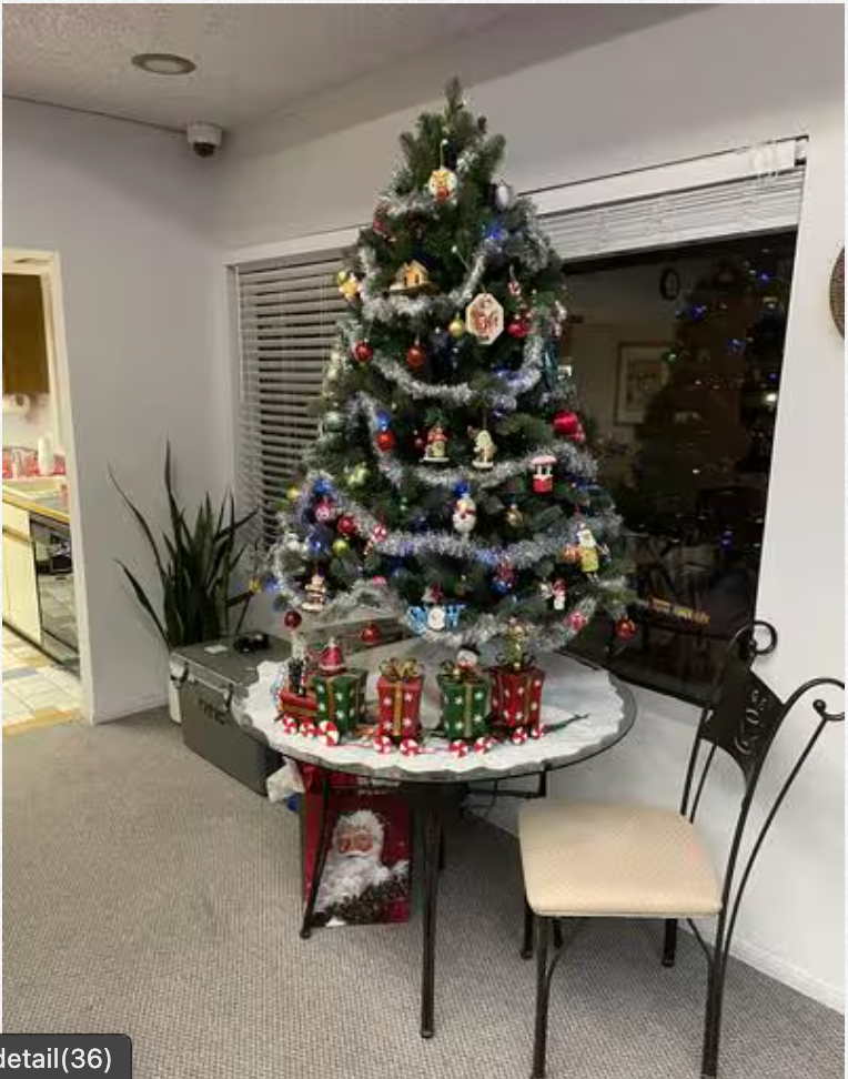A christmas tree is sitting on a table in a living room.