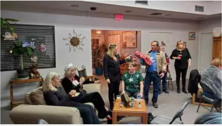 A group of people are sitting on a couch in a living room.