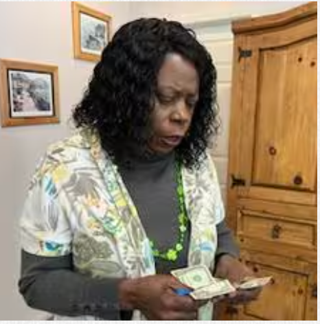 A woman is holding a bunch of money in her hands.