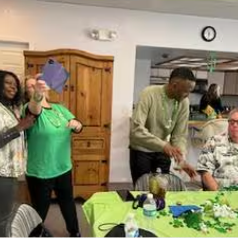 A group of people are sitting at a table in a room.