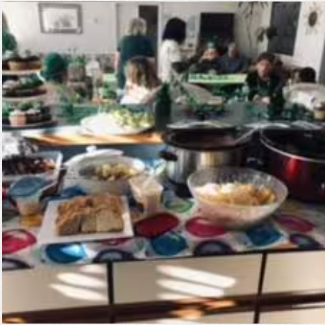 A table topped with plates of food and pots and pans.