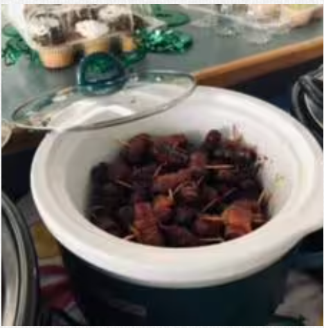 A bowl of food with a glass lid is sitting on a table.