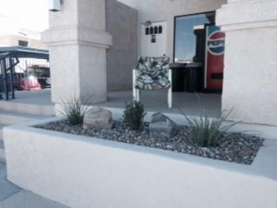A pepsi vending machine is on the side of a building