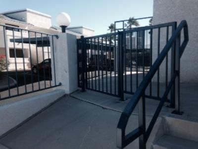 A black fence with stairs leading to it