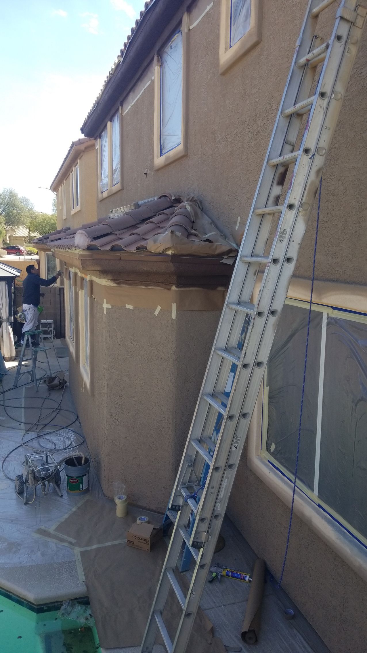 A ladder is leaning against the side of a house.