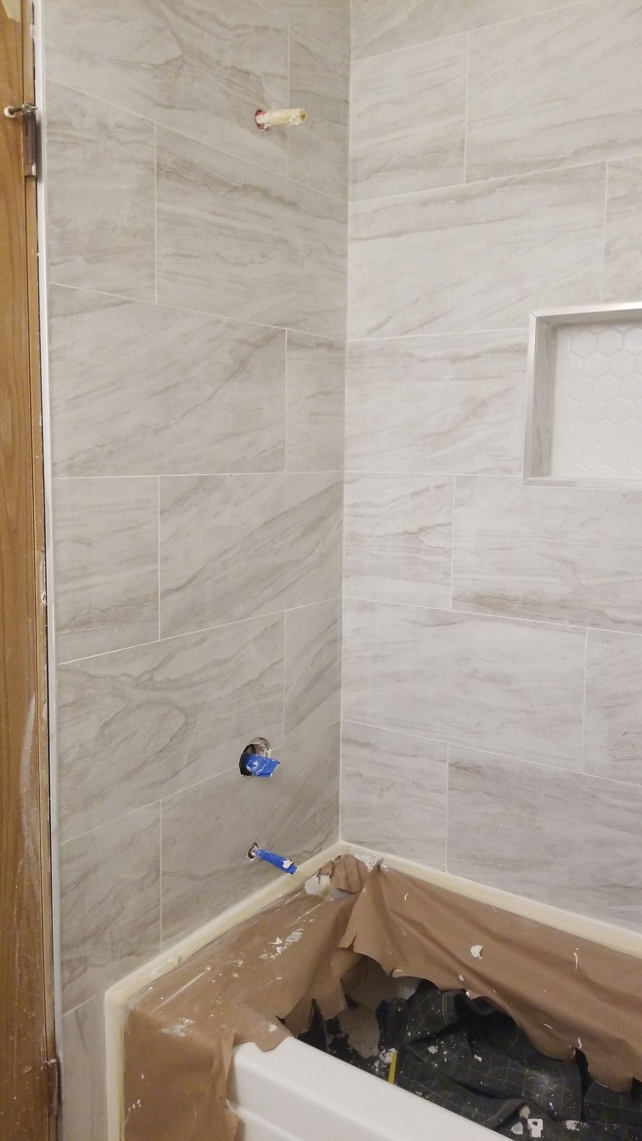 A bathroom under construction with a bathtub and shower.