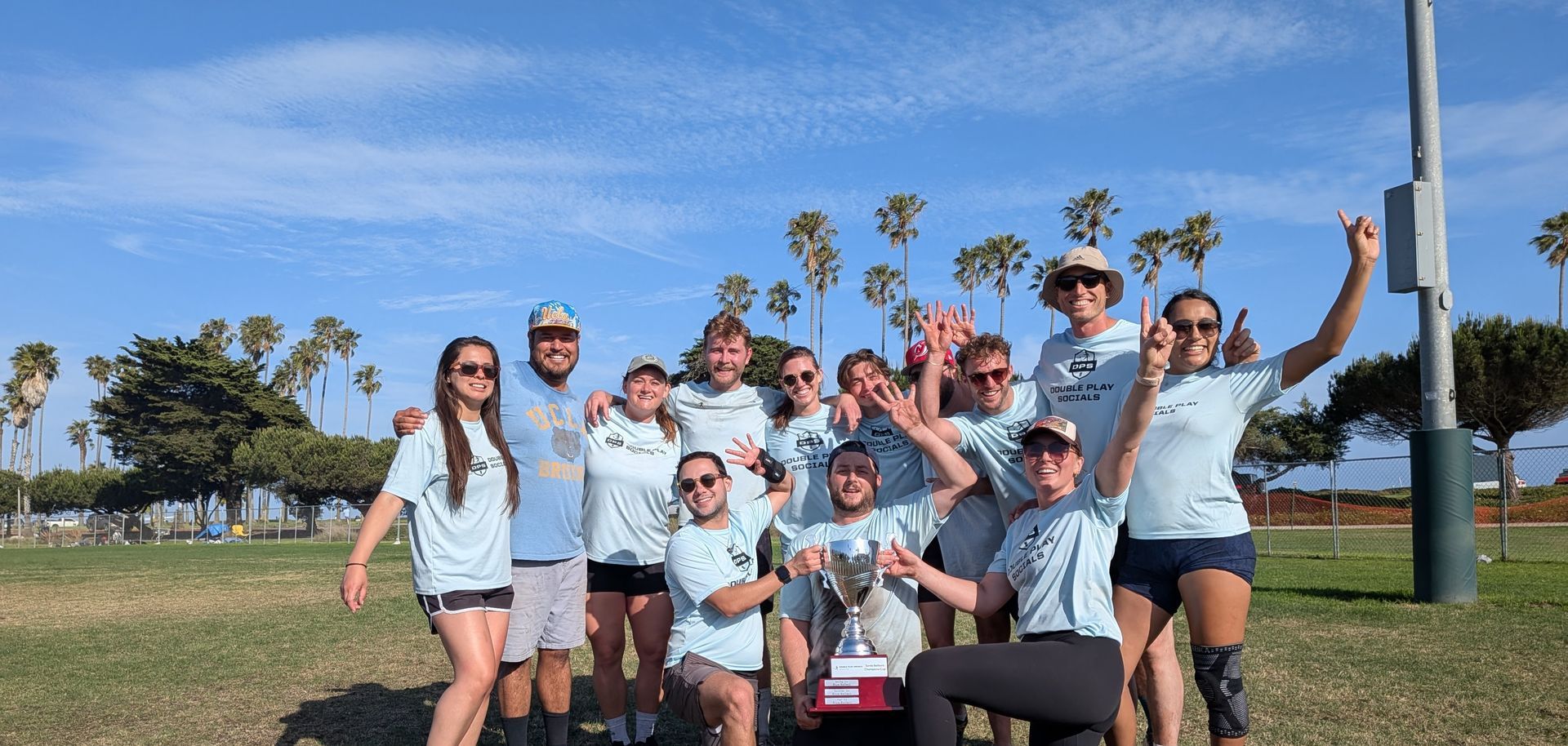 Double Play Socials kickball Blue Ballerz team posing after winning a championship.