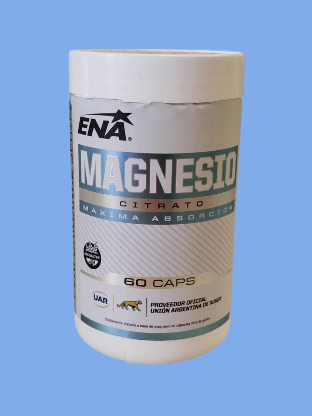 Envase cilíndrico blanco de suplementos de citrato de magnesio de la marca ENA, con fondo azul. Contiene 60 cápsulas.