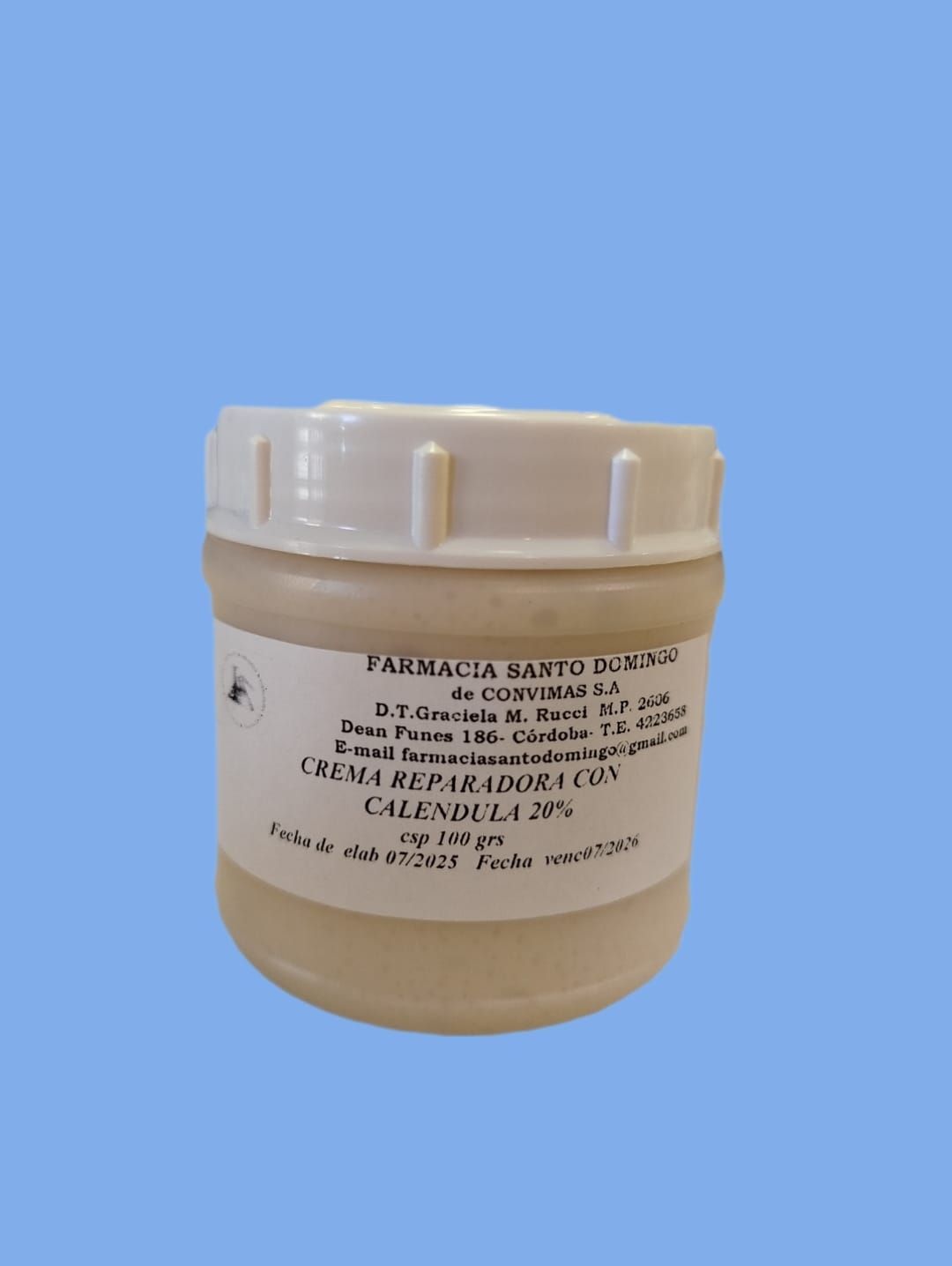 Tarrina blanca de crema “Crema Reparadora Lux” con texto en etiqueta, sobre fondo azul.