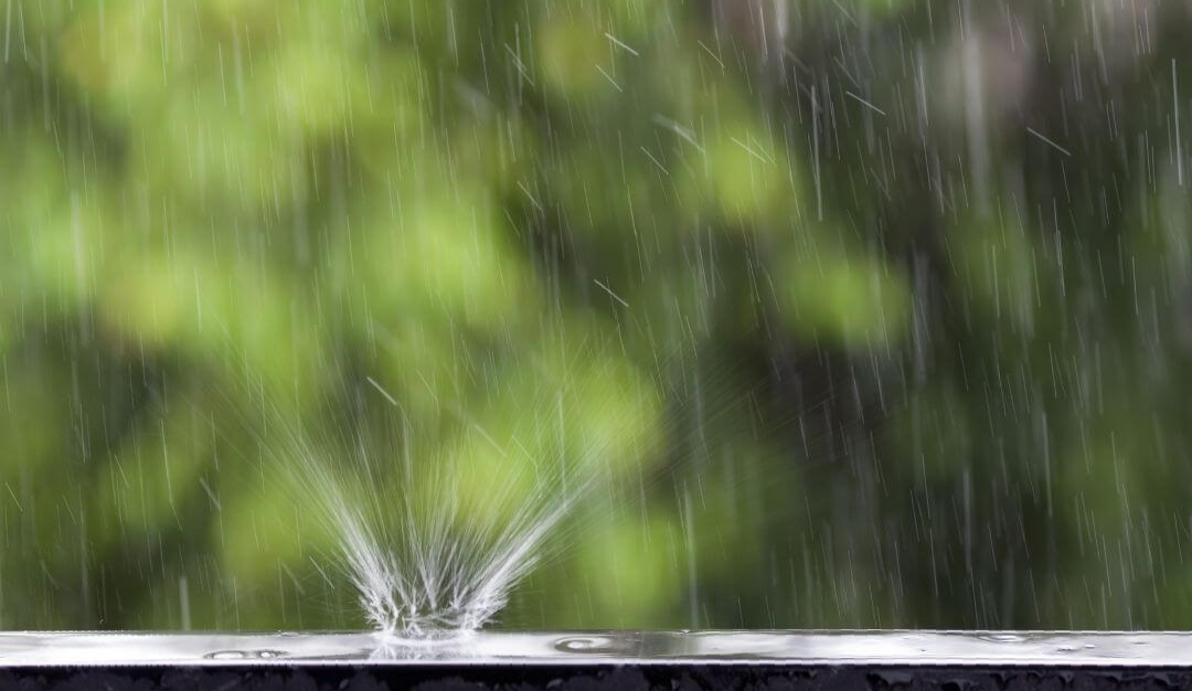 heavy rainfall with water droplet smacking against railing