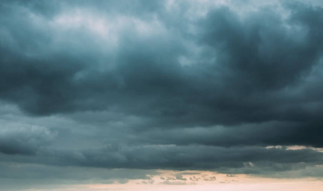 dark rain clouds preparing to rain on a grassland