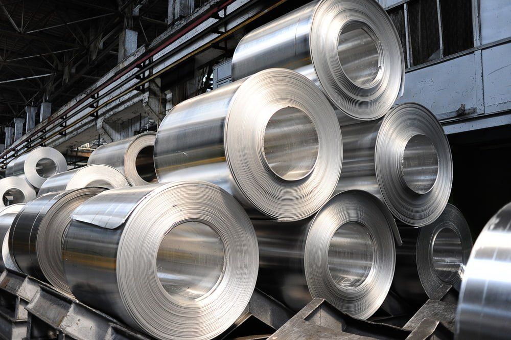 A Bunch of Aluminum Rolls Are Stacked on Top of Each Other in a Factory — NQBC Pty Ltd in Emerald, QLD