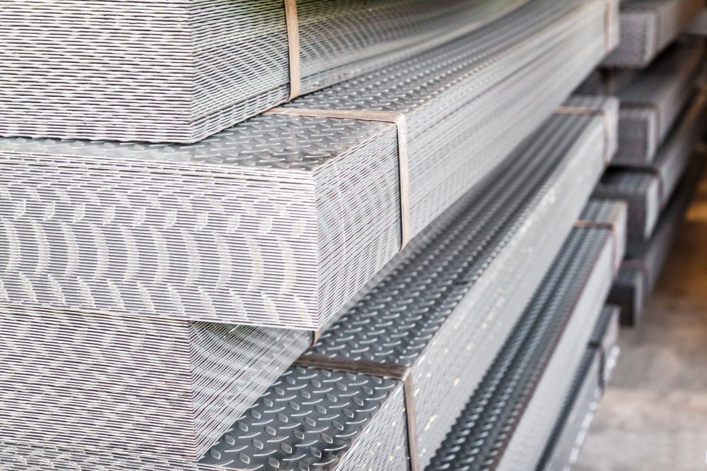 A Stack of Metal Sheets Stacked on Top of Each Other in a Warehouse — NQBC Pty Ltd in Bowen, QLD