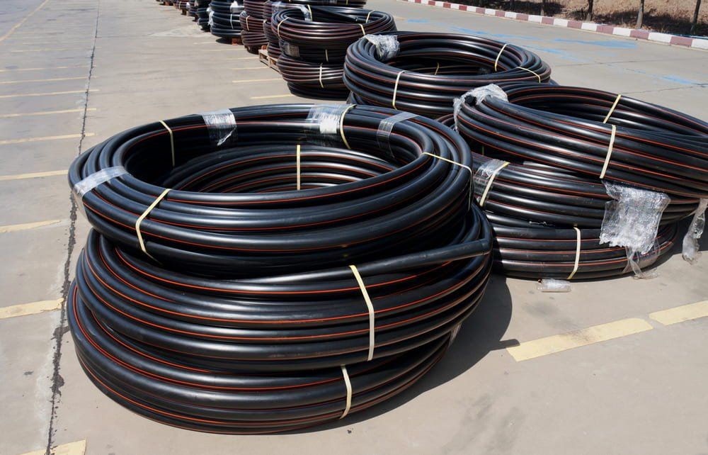 A Bunch of Black Pipes Are Stacked on Top of Each Other — NQBC Pty Ltd in Emerald, QLD