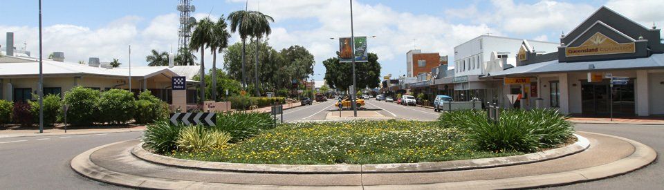 A Roundabout in the Middle of a Street With Buildings in the Background — NQBC Pty Ltd in Ayr, QLD