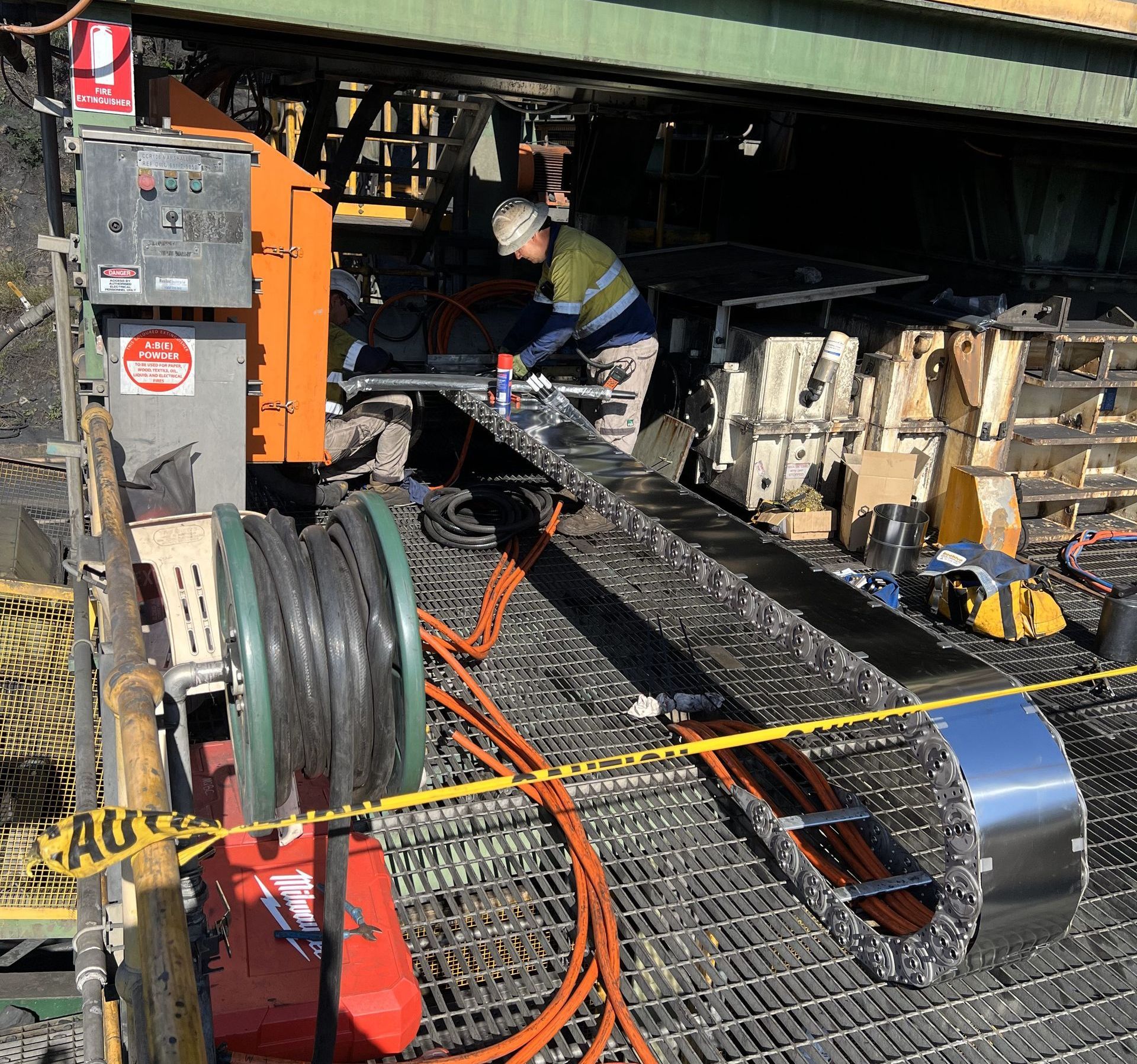 A Man is Working on a Machine Under a Bridge — NQBC Pty Ltd in Bowen, QLD