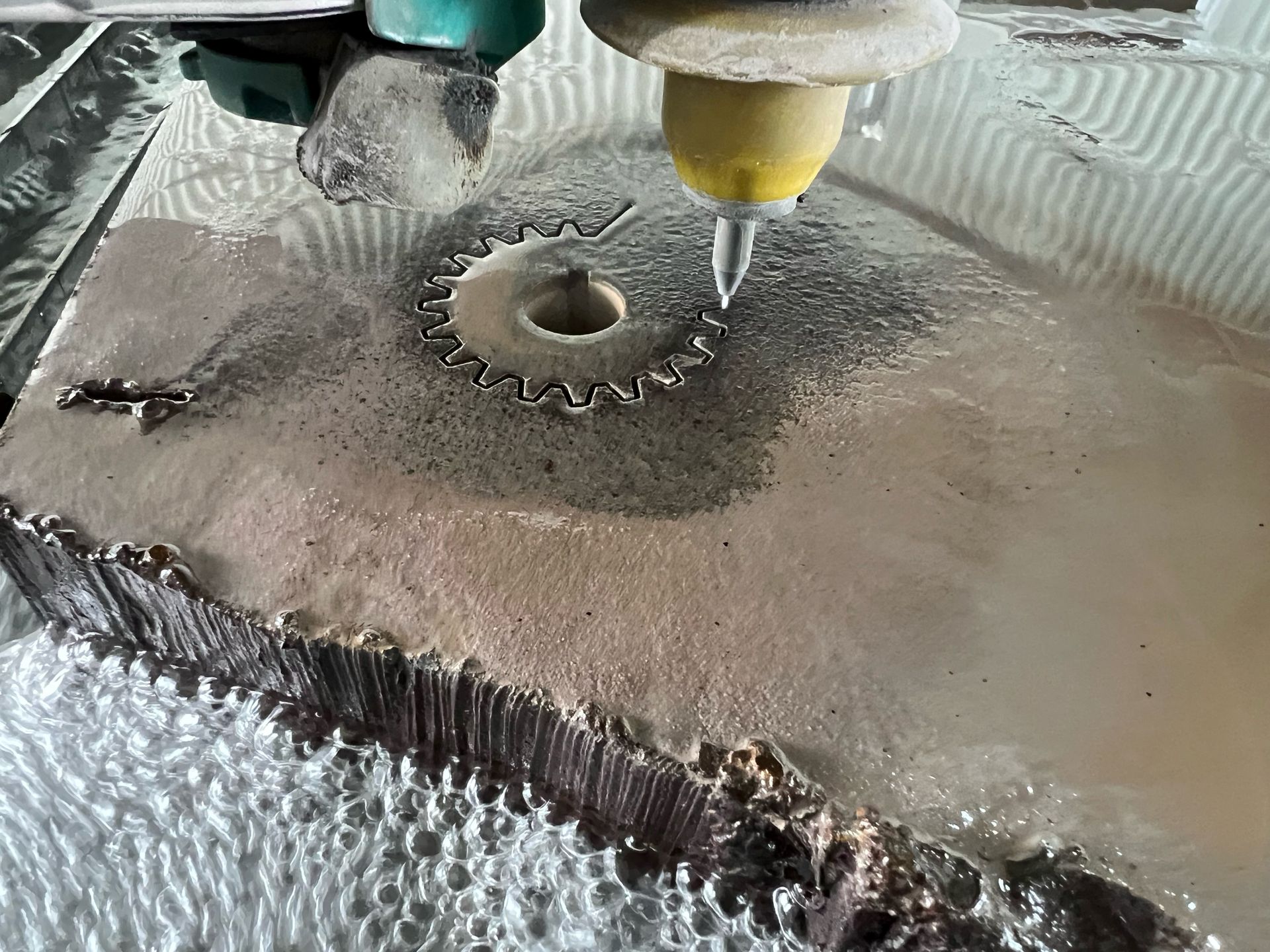 A Machine is Cutting a Piece of Metal With Water — NQBC Pty Ltd in Bowen, QLD