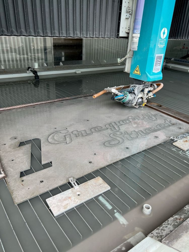 A Machine is Cutting a Piece of Metal With Water — NQBC Pty Ltd in Moranbah, QLD