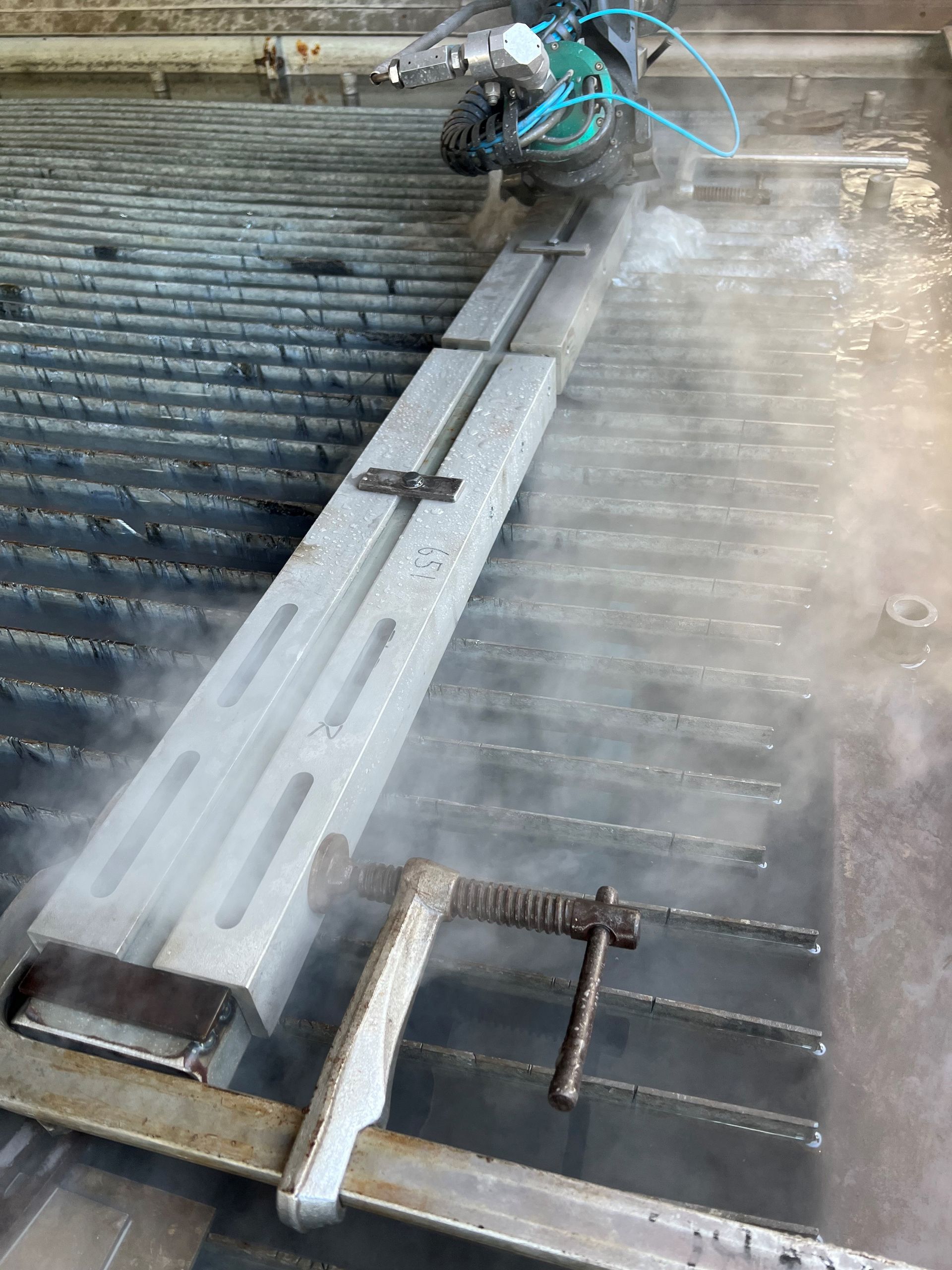 A Person is Cutting a Piece of Metal With a Machine — NQBC Pty Ltd in Bowen, QLD