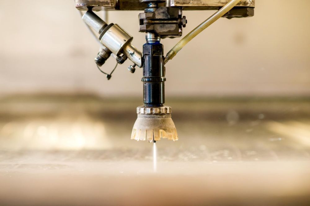 A Machine is Cutting a Piece of Metal With Water — NQBC Pty Ltd in Proserpine, QLD