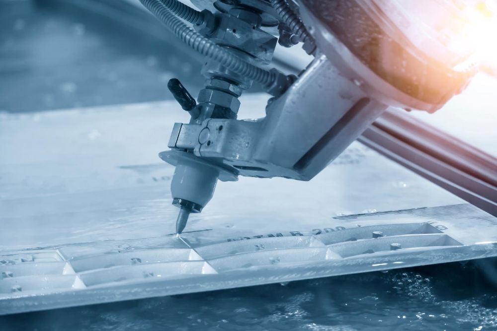 A Machine is Cutting a Piece of Metal With Water — NQBC Pty Ltd in Moranbah, QLD