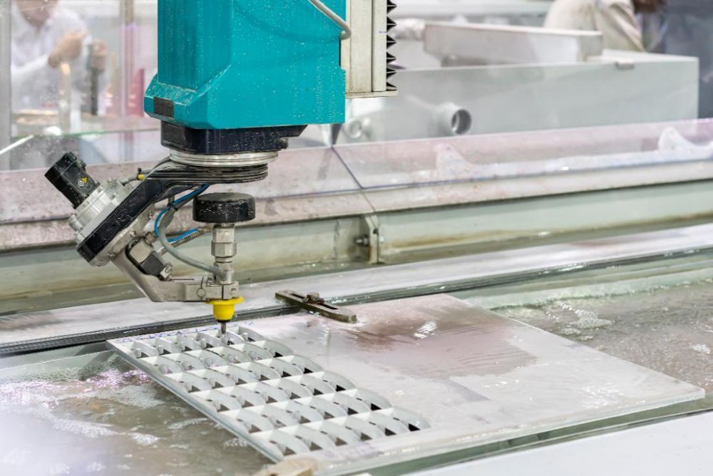 A Machine is Cutting a Piece of Metal With Water — NQBC Pty Ltd in Moranbah, QLD