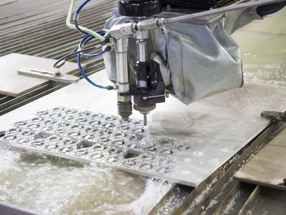 A Machine is Cutting a Piece of Metal With Water — NQBC Pty Ltd in Collinsville, QLD