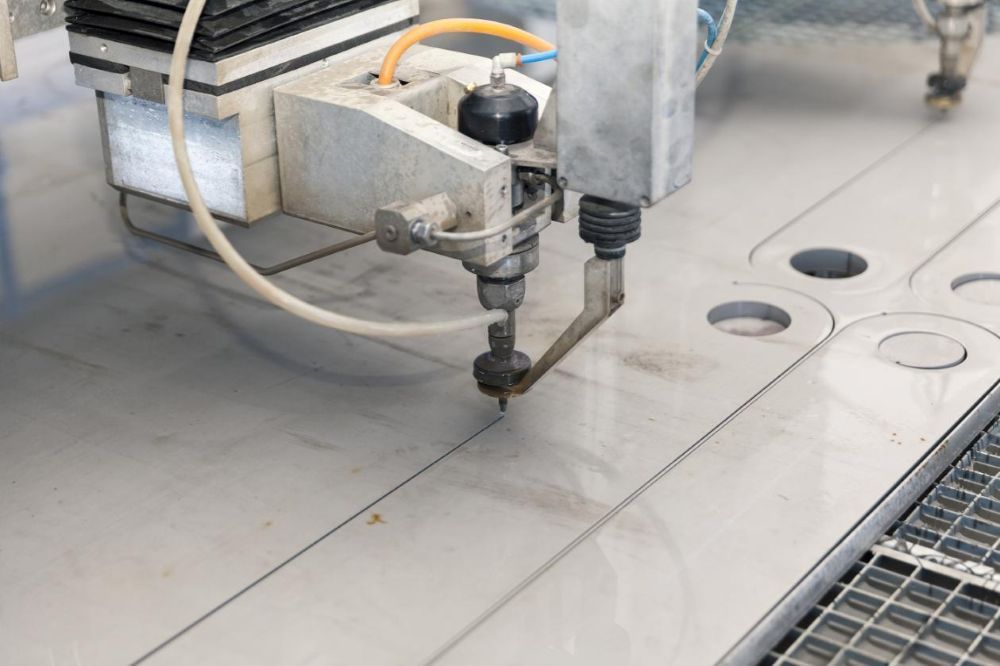 A Machine is Cutting a Piece of Metal With Water — NQBC Pty Ltd in Collinsville, QLD