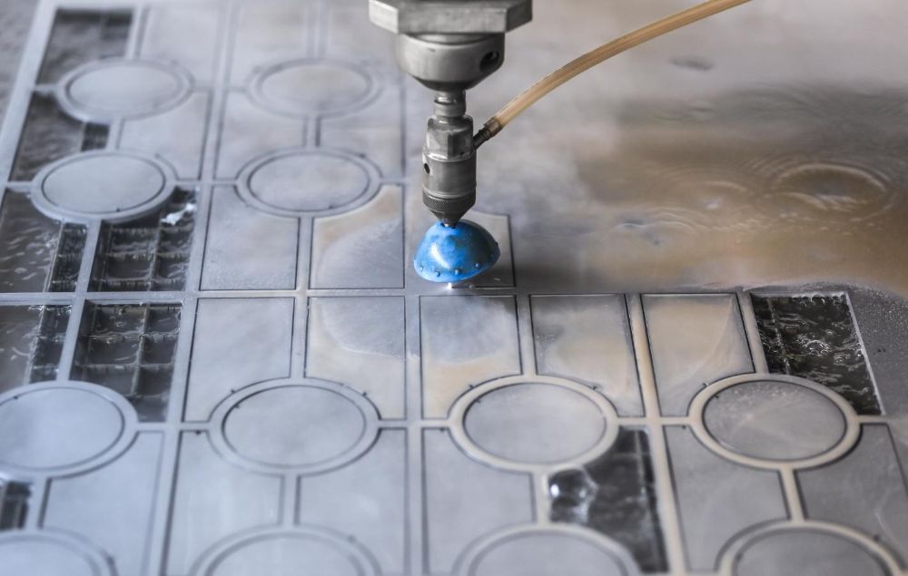 A Machine is Cutting a Piece of Metal With Water — NQBC Pty Ltd in Ayr, QLD