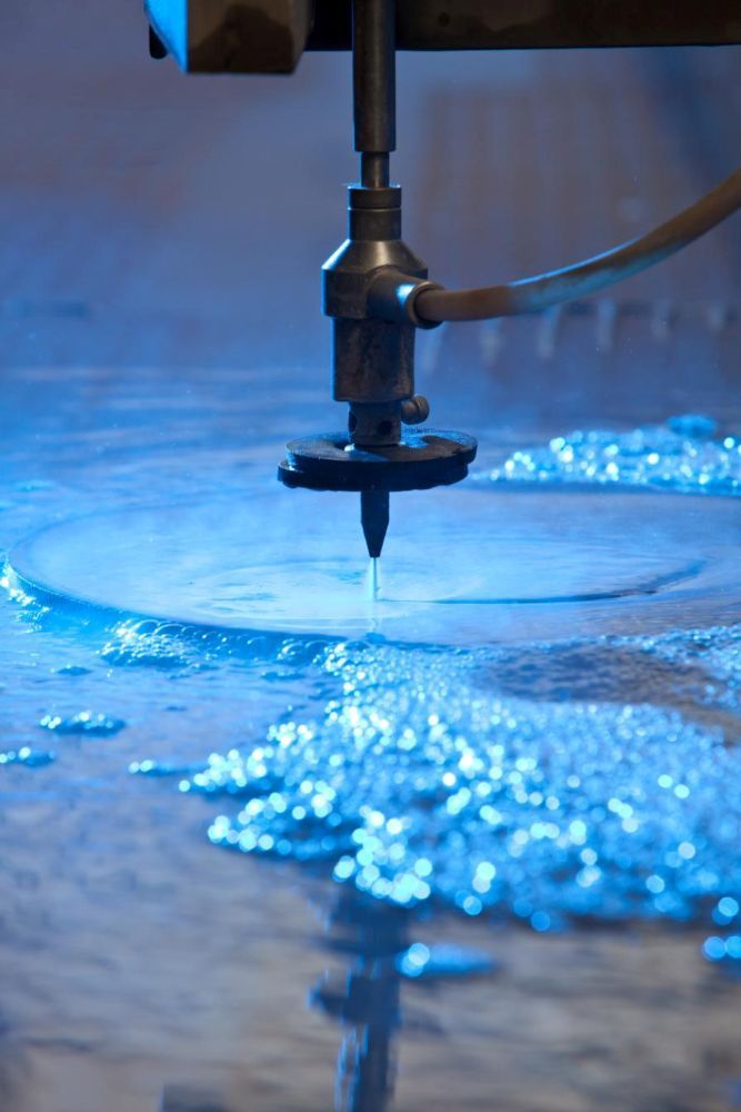 A Machine is Cutting a Piece of Metal With Water — NQBC Pty Ltd in Proserpine, QLD
