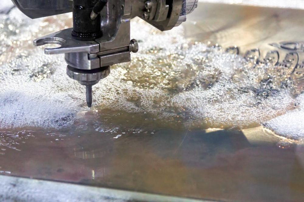A Machine is Cutting a Piece of Metal With Water — NQBC Pty Ltd in Proserpine, QLD