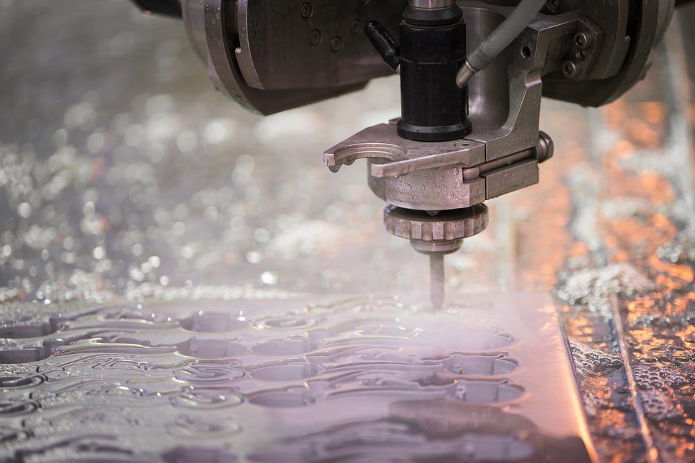 A Machine is Cutting a Piece of Metal With Water — NQBC Pty Ltd in Bowen, QLD