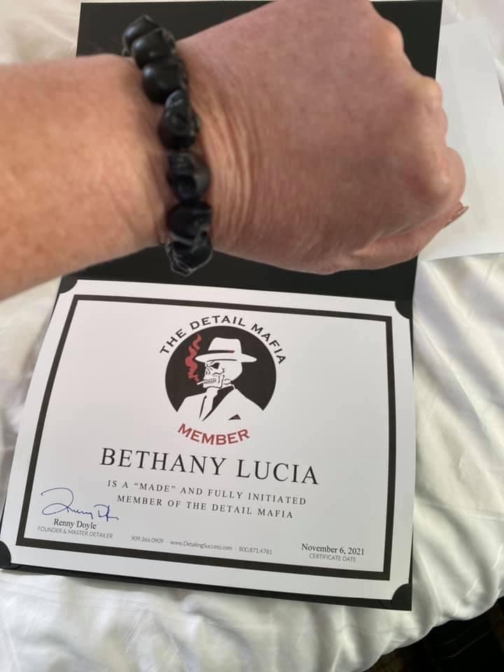 Person wearing a skull bead bracelet, holding a