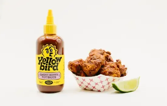 Super chix ghost pepper nuggets with yellowbird classic ghost pepper hot sauce.