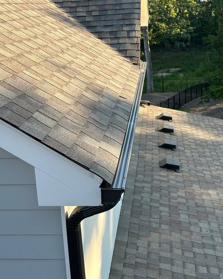 A close up of a gutter on the roof of a house.