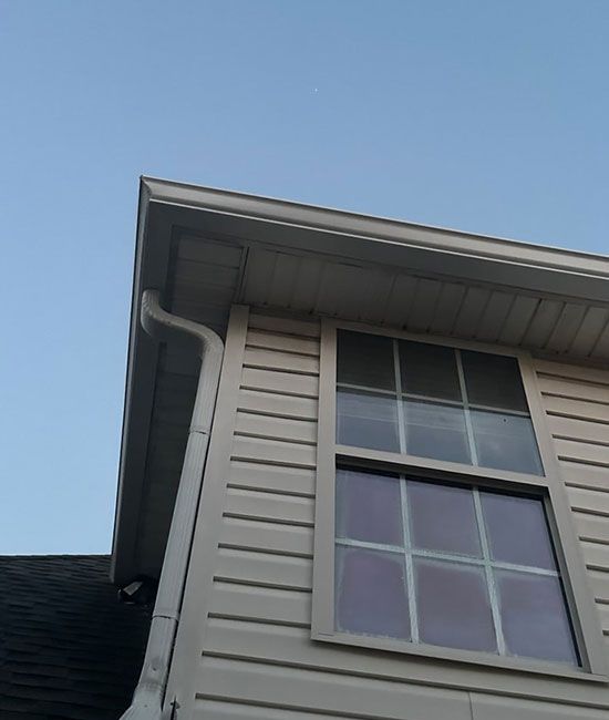 A house with a window and a gutter on the side
