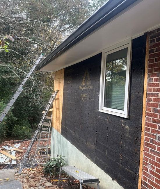 A ladder is leaning against the side of a house