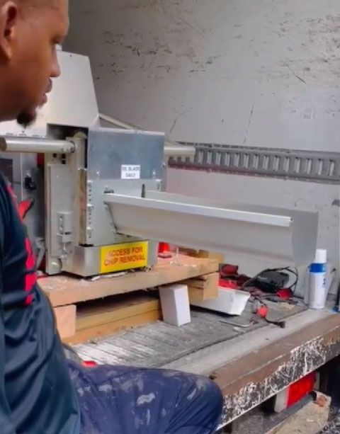 A man is sitting in a truck looking at a machine