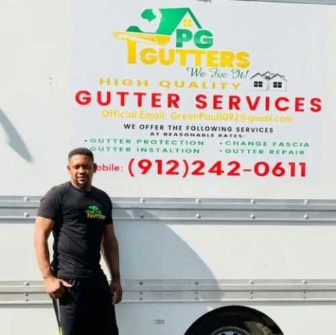 A man standing in front of a truck that says gutter services