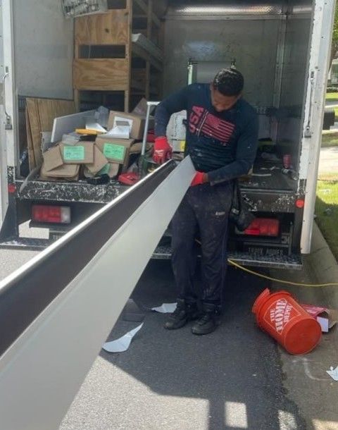 A man is working in the back of a home depot truck