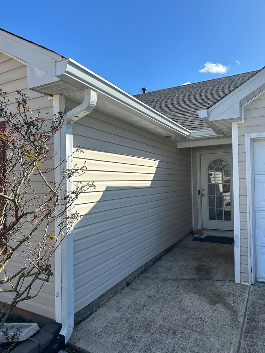 A large house with a sign in front of it.